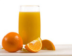 Fresh squeezed orange juice surrounded by fresh oranges on white background